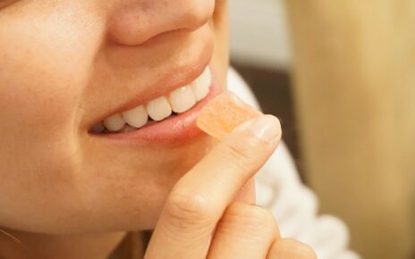 woman holding orange and white candy